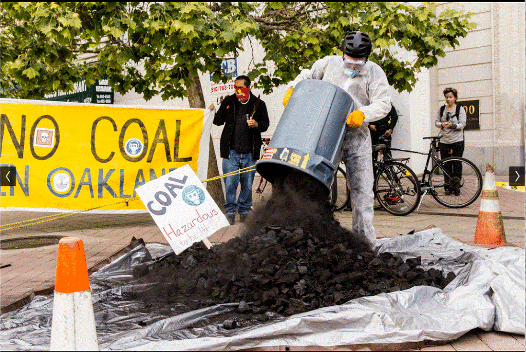 a man emptying a dustbin of coal