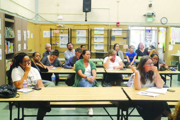 parents of the school student are sitting in classroom